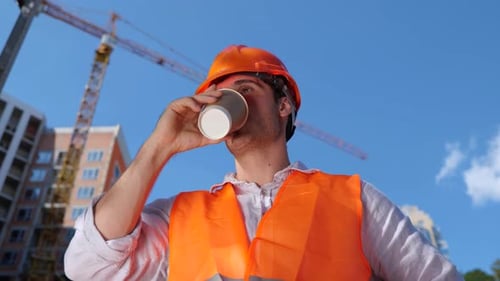 Builder in Working Uniform Drinking Coffee While Standing Construction Site Business Building