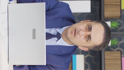 Man in Suit Speaking then Stressed at Computer