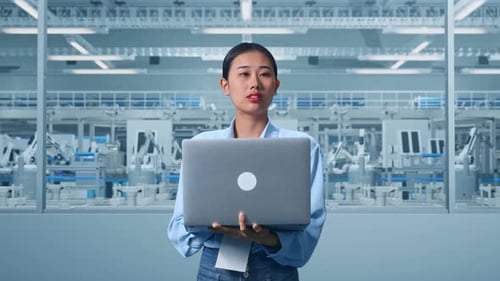 Asia Female Worker Use Laptop And Looking Around at Factory Digitalization