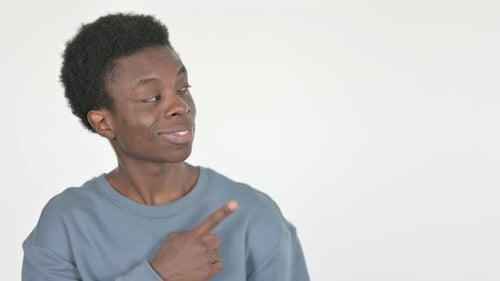 Smiling Young Adult Points to the Side