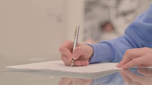 Close up of Young Woman Hand Writing a Letter