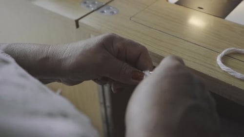 Woman's Hands Knitting White Yarn with Needles