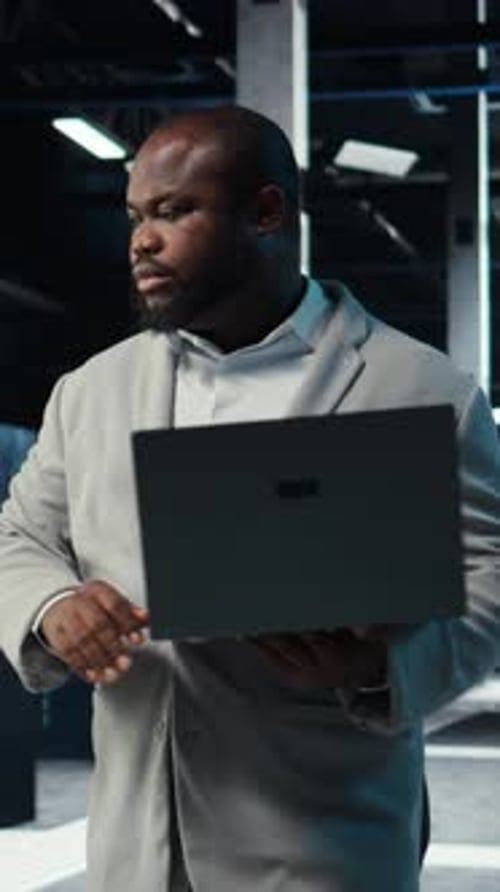 Vertical Video Data Center Admin Coding Writing Script on Laptop Identifying Bottlenecks