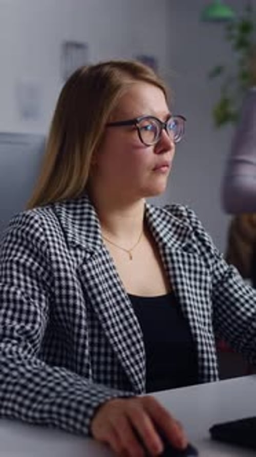 Woman Working on Computer in Modern Office Setting