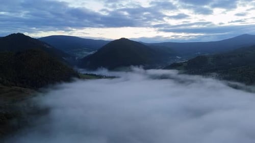 Aerial View Clouds and Mist Moving Carpathians Mountains Landscape with Fogcovered Peaks