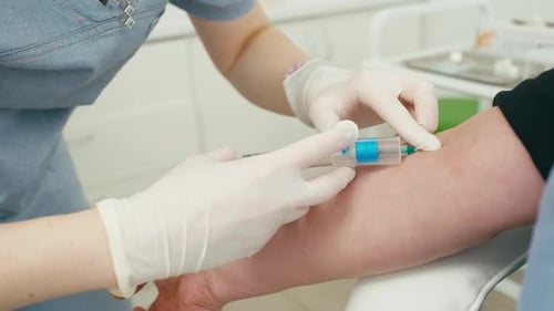 A Closeup of the Installation of the System for Taking Blood From a Vessel