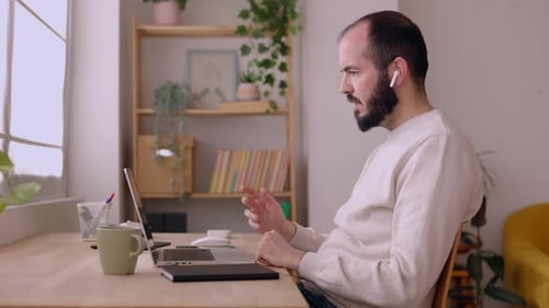 Man Working from Home on Laptop Video Call