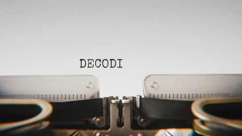 Old mechanical typewriter typing Decoding Message in a close-up view.