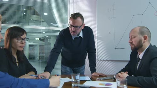 Team Collaboration Analyzing Sales Data at a Business Meeting