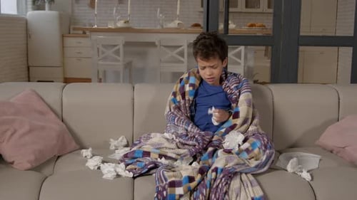 School Age Black Suffering From a Flu and Cold Blowing Nose Into Tissue