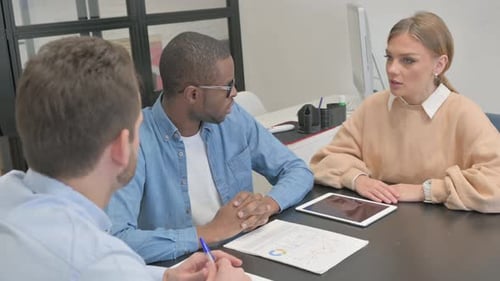 Colleagues Meeting at Office Table Discussing Data