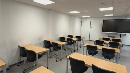 Clean Empty Classroom with Desks and Whiteboard