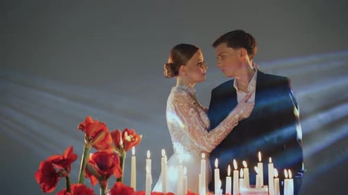 Loving Couple Embrace Surrounded by Candles and Flowers