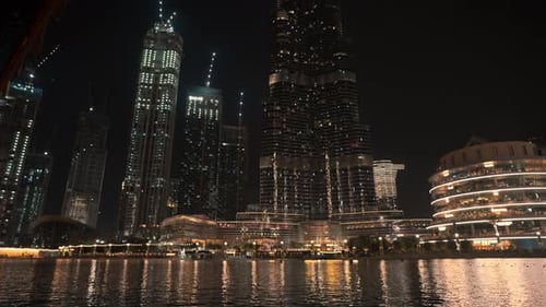 Shot By The River Focusing On Dubai's Cityscape At Night