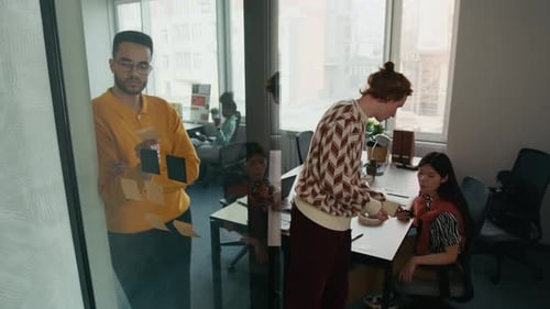 Workers Collaborate in Modern Urban Office