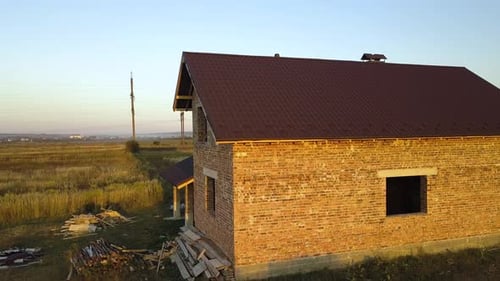 Aerial View of Unfinished House with Wooden Roof Structure Covered with Metal Tile Sheets Under