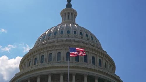 US Capitol Building Dome and American Flag Waving