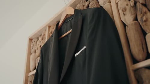 close up of elegant groom suit jacket on hanger