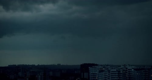 Dark Clouds Over City at Night