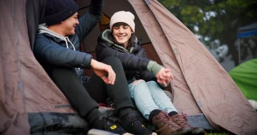 Young Couple Smiling in a Tent at Campsite
