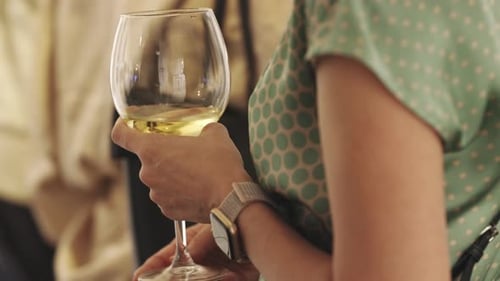 Woman holding a glass of white wine