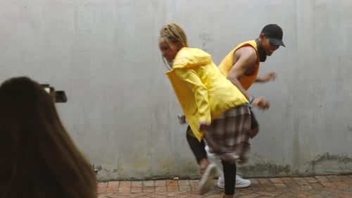 Man dance with black woman, recording hip hop video or social media post
