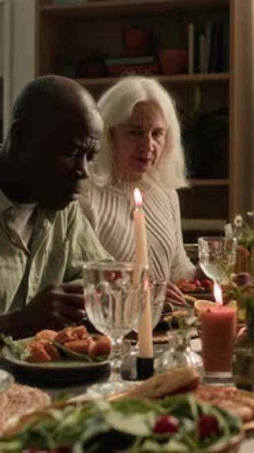 Family and Friends Eating Meal Together at Table