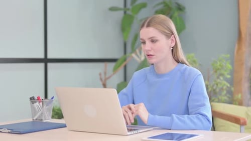 Woman On Laptop During Video Call At Desk