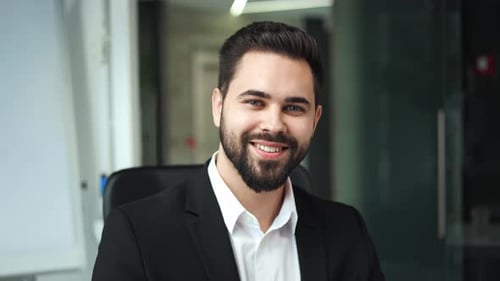 Smiling Young Adult Man in an Office