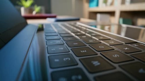 Closeup Detailed Laptop Keyboard on Modern Office Desk Dolly Shot Computer