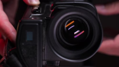 Finger Pushing Record on Video Camera Lens Close Up