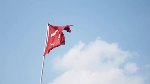 Turkish Flag Waving Against a Blue Sky