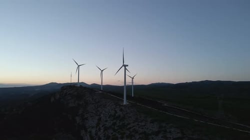 Wind Turbines on Rolling Hills at Sunrise