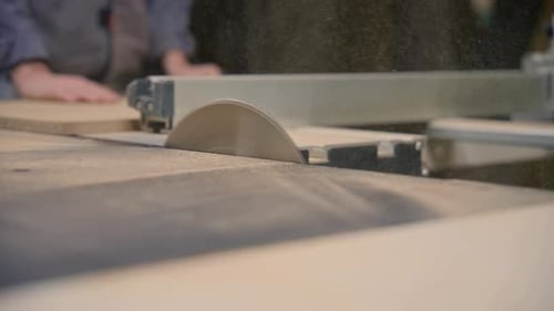 Woodworker Cuts Wood on Table Saw in Workshop