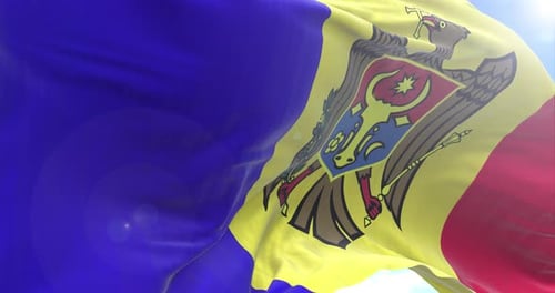 Realistic Waving Flag of Moldova against Blue Sky