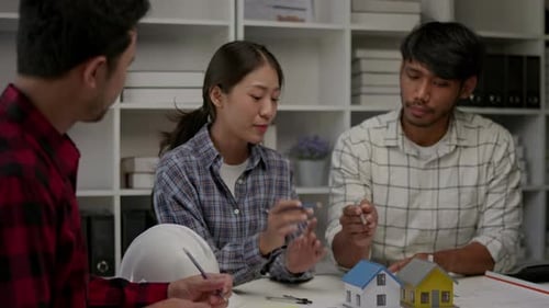 Hands working brainstorming and measuring for cost estimating on architectural and engineering.