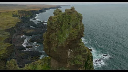 Aerial view of wild coastline with cliffs and rock formation in Iceland.