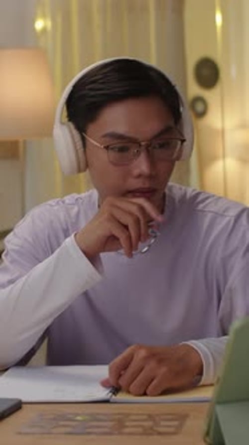 Young Adult Studying Diligently at Desk in Evening