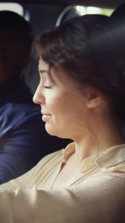 Woman Sits in Car with Companion