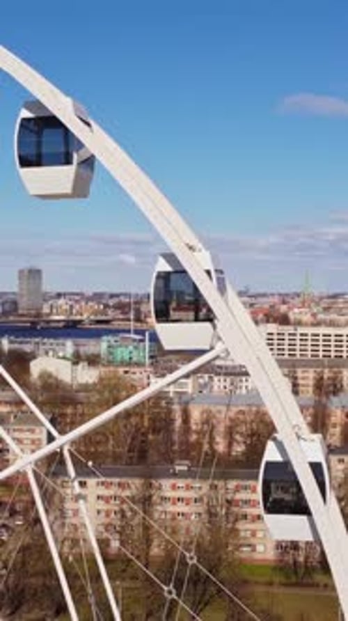 Vertical Close Up of Ferris Wheel Over Pārdaugava – Riga in Motion