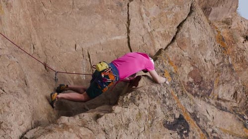 Man Athlete Climbing on the High Rock