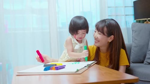 Mother and Daughter Drawing Together at Home