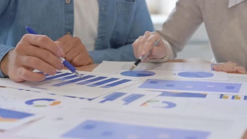 Close Up of Multi Ethnic People Working on Documents