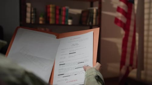 Military Person Reading Classified Documents Indoors