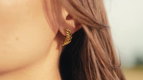 Woman Wearing Golden Leaf Earring