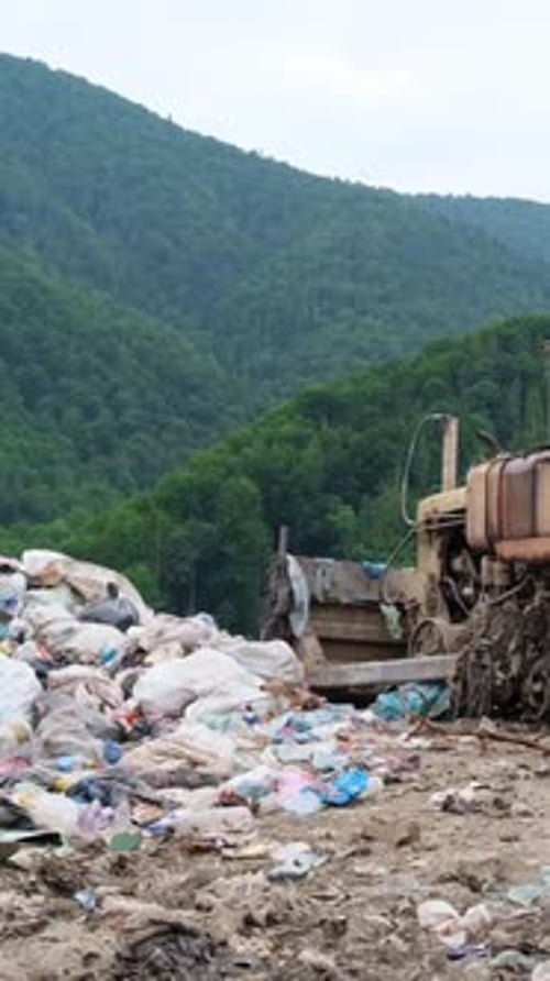Bulldozer Sits Atop Huge Trash Heap at Landfill