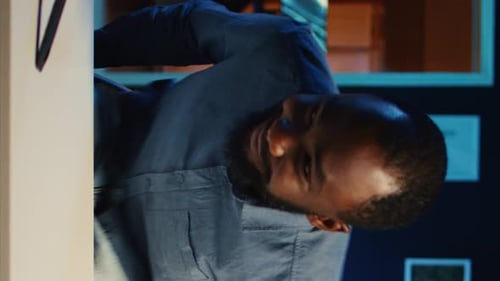 Man Gesturing and Speaking in Dark Room