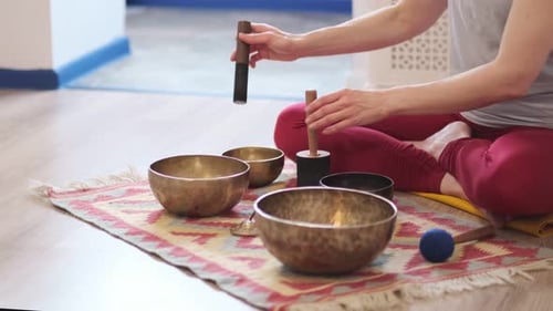 Woman Plays Singing Bowls for Meditation and Wellness
