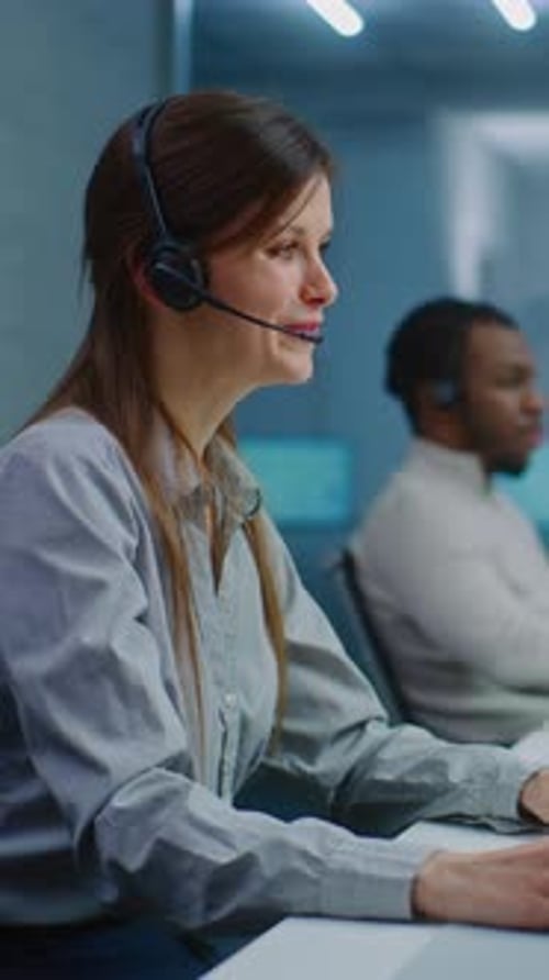 Female Hotline Operator Talks on Headset Works on Computer Provides Online Help for Client