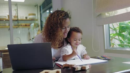 Woman Working At Home With Child Drawing